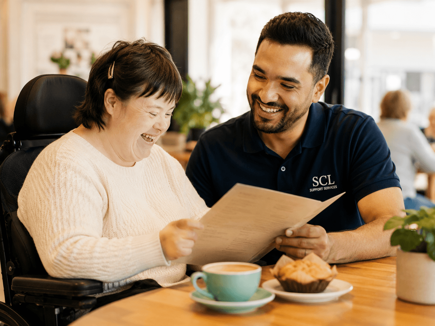 Support worker and participant together mid-activity, sharing a relaxed and genuine moment.